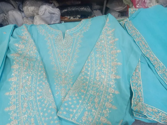 Gold embroidery on a sky-blue suit
