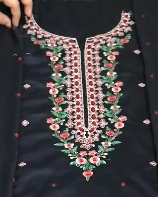 Close-up of a black suit with red and green neckline embroidery
